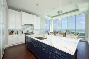 Kitchen after cabinet painting at 19 Ocean Ridge with smooth spray finish and updated color